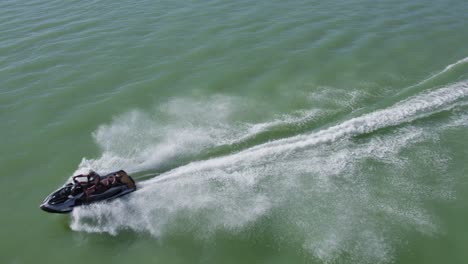 Aerial-Drone-View-Above-One-Person-Riding-and-Speeding-on-Jet-Ski-Sea-Doo