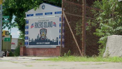 Low-Angle-Handheld-Shot-Of-Rikers-Island-Jail-Sign-In-NYC