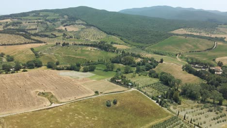 Aerial-images-of-Tuscany-in-Italy-cultivated-fields-summer,-Grosseto-Livorno-cured-meat