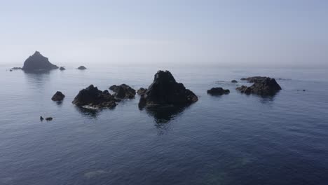 Calm-water-and-misty-coastal-rock-islets-of-South-Ireland's-Celtic-Sea