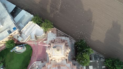 Aerial-top-angle-shot-of-bird-flying-near-the-palitana-temple