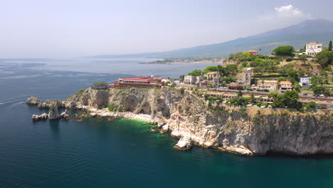 Aerial-shot-of-the-Isola-Bella-coastline-and-the-Ionian-Sea