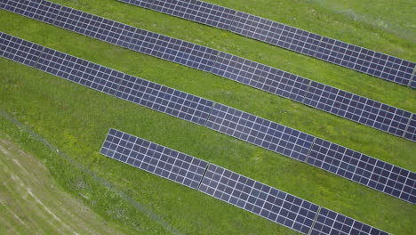 Aerial-landing-shot-showing-Solar-Panel-Farm-Sun-Energy-Conservation-Power-Supply-Sunset-Green