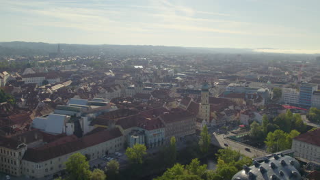 Aerial-view-above-scenic-historic-Graz-renaissance-city-architecture-rooftops-far-across-the-skyline