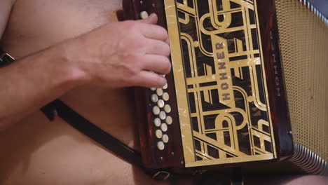 Shirtless-Musician-Playing-Hohner-Diatonic-Accordion-Instrument,-Music-Performance-Dexterity-and-Art-Skill-Using-Hands-for-Compressing-Expanding-and-Fingers-on-Keyboard-Buttons