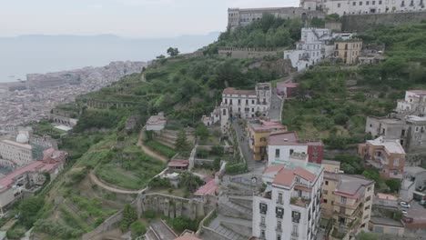 Rotating-aerial-footage-of-the-staircase-that-leads-up-the-hill-to-Castel-Sant'Elmo-in-Naples,-Italy