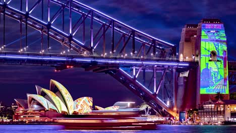 Timelapse-close-shot-of-the-Harbour-Bridge-and-opera-house-while-boats-pass-during-Sydney's-Vivid-festival-2022