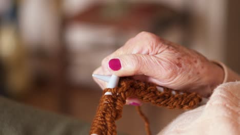 Grandma's-wrinkly-fingers-while-knitting-with-brown-wool