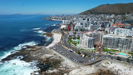 rocky-coastline-of-Sea-Point-in-Cape-Town-South-Africa-on-sunny-summer-day,-aerial