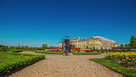 Static-shot-of-tourists-with-cameras-taking-photos-of-Rundale-Palace-in-Latvia-in-timelapse-at-daytime