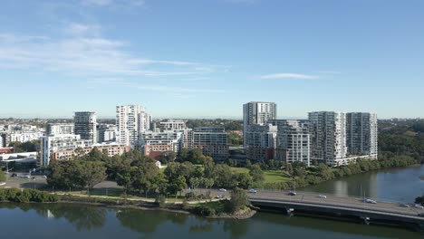 Aerial-reveals-shot-of-high-rise-waterfront-apartment-complexes-on-a-sunny-day