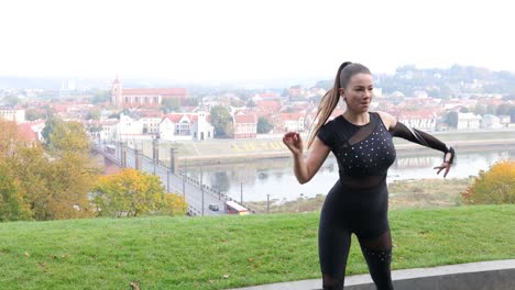 Close-up-of-a-female-dancer-dancing-outside-in-front-of-amazing-city-view