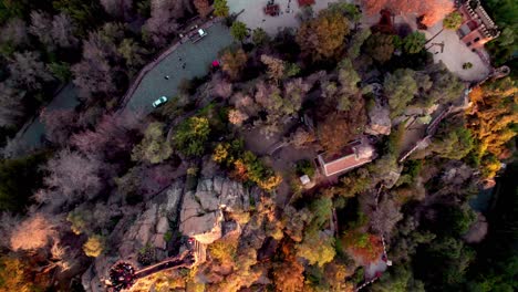Aerial-top-down-lowering-over-Benjamín-Vicuña-Mackenna-Tomb-at-Santa-Lucial-Hill-covered-in-autumnal-trees,-Santiago,-Chile