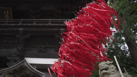 Red-Streamers-from-Sagicho-Matsuri-Celebrations-at-Hachiman-Shrine,-Blowing-in-Wind