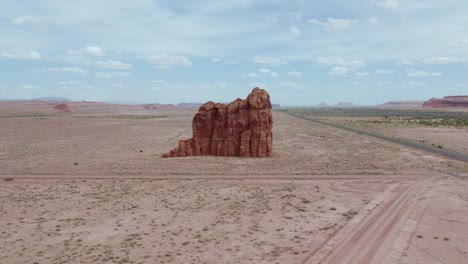 Aerial-view-of-orange-large-sandstone-rock-formation-and-desert