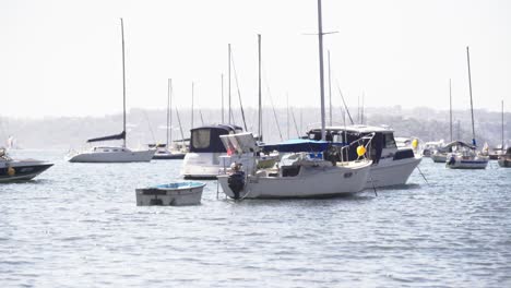 Boats-bobbing-on-the-water-in-little-bay-on-mooring-anchor