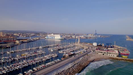 Marina-with-lighthouse-and-GNV-Italian-cruise-docked-in-the-port,-Aerial-flyover-shot