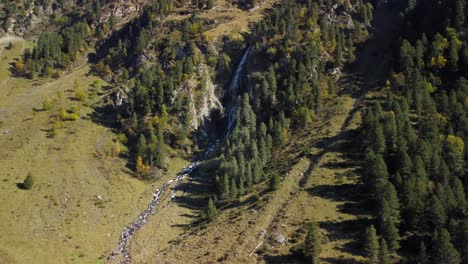 Drone-aerial-view-of-a-waterfall-in-LÃ¼sens-Valley-in-october,-located-in-Austria