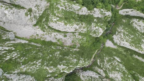 Drone-ascent-revealing-rocky-valley-in-Asturias,-north-Spain