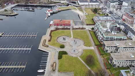 Aerial-above-Nupen-water-fountain-and-Otterdalen-marina-close-to-Odderoya-in-Kristiansand-city-center---Norway