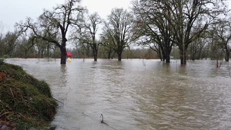 Wide-shot-of-floodplain-as-high-water-levels-cause-creek-to-overflow-in-flood