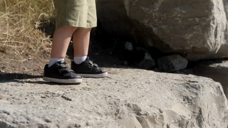A-kid-being-adventurous-walking-on-top-of-big-rocks