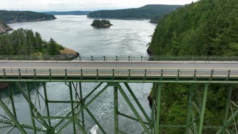 Panning-aerial-shot-of-a-truck-driving-over-the-bridge-at-Deception-Pass