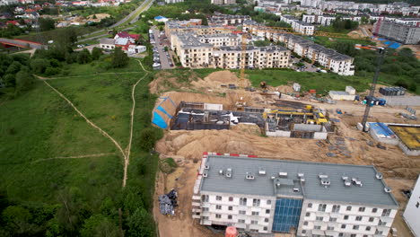 Apartments-Condominium-Emerging-Residential-Buildings-Area-in-Gdansk-City-Neighborhood-Poland,-Construction-Site-and-Urban-Development-on-Sandy-Ground-next-to-Green-Land-and-Route,-Aerial-view
