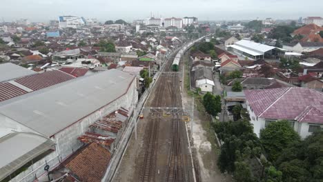 aerial-view,-The-train-that-runs-slowly-begins-to-depart-from-Lempuyangan-Yogyakarta-station-and-shows-a-view-of-the-city-of-Yogyakarta