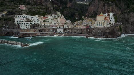 Establishing-Aerial-Tilt-up-to-Spiaggia-di-Atrani-Town-on-Amalfi-Coast,-Italy