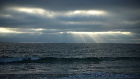 Heavens'-rays-shining-through-the-clouds-over-the-moody-ocean-landscape---static