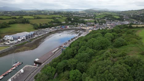 Bantry-town-in-south-west-County-Cork,-Ireland-reveal-over-trees-aerial-drone-view