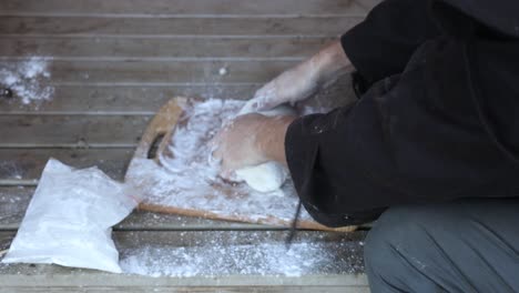 A-close-up-of-a-bushmans-hands-as-he-creates-damper-with-flour