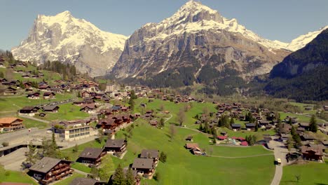 Aerial-drone-footage-pushing-out-over-picturesque-mountain-village-grindelwald