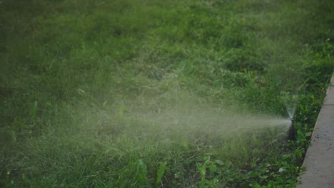 Automatic-Sprinkler-System-Watering-The-Lawn-On-A-Yard