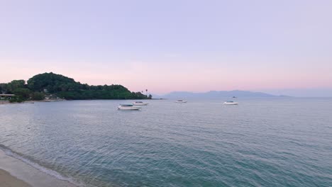 Colorful-4k-Drone-Sunset-Ocean-Views-Over-the-Coast-at-Bo-Phut-Beach-in-Koh-Samui-Thailand,-Including-Anchored-Yachts,-Coconut-Palms,-and-Beachfront-Resorts