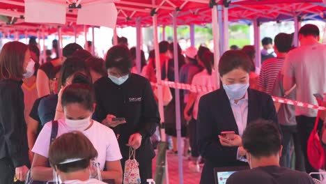 People-queue-in-line-and-register-to-receive-PCR-tests-for-coronavirus-from-a-Community-Testing-Centre-truck-to-tackle-the-spread-of-the-virus-and-a-pandemic-wave-in-Hong-Kong