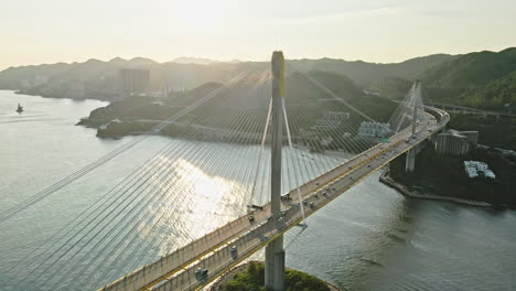 Cars-crossing-Ting-Kau-Bridge-in-Tsing-Yi,-Hong-Kong,-aerial-view-in-sunrise