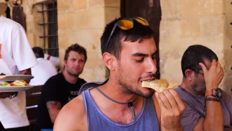 Male-Tourist-Enjoying-Biting-Into-Puff-Pastry-At-Cafe-In-Nicosia