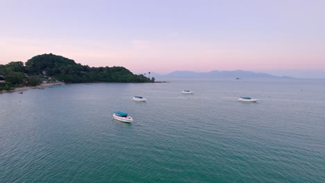 Colorful-4k-Drone-Sunset-Ocean-Views-Over-the-Coast-at-Bo-Phut-Beach-in-Koh-Samui-Thailand,-Including-Anchored-Yachts,-Coconut-Palms,-and-Beachfront-Resorts