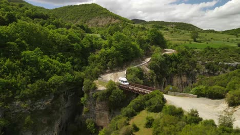 Aerial-zoom-in-shot-of-a-metal-bridge-in-the-Osum-gorge-in-Albania