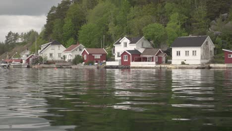 Typical-Wooden-Homes-On-Idyllic-Lakeshore-In-Countryside-Of-Norway