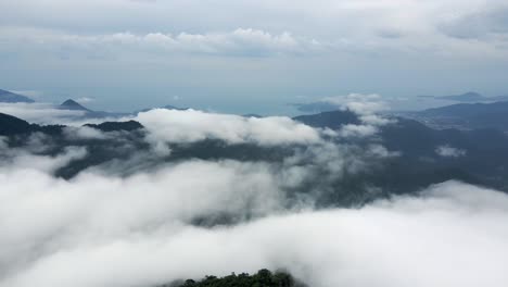 Slow-aerial-flying-backwards-over-Serra-do-Mar-covered-by-clouds,-Brazil
