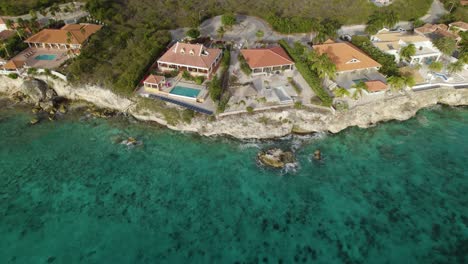 Aerial-trucking-shot-of-the-vacation-villas-on-shore-in-the-Caribbean