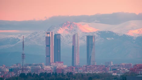 Timelapse-of-Madrid-5-towers-skyline-and-snowy-sierra-mountain-during-sunrise