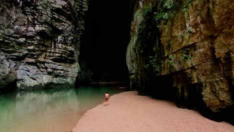 Arco-del-Tiempo,-Chiapas,-Mexico,-Sone-Arch,-cave,-River-in-Canyon,-Drone-Shot,-woman-walking
