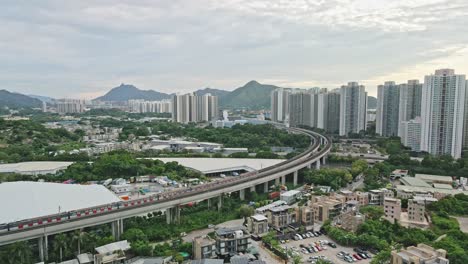 MTR-Tuen-Ma-Line-crossing-bridge-towards-station,-Tin-Shui-Wai,-Hong-Kong
