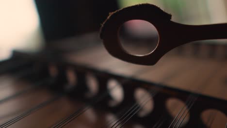 Extreme-close-up-of-dulcimer-Appalachian-traditional-musical-instrument,-cinematic-slow-motion-hammered-string
