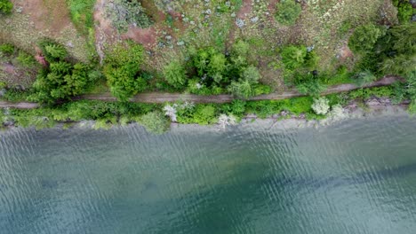 Panning-drone-shot-of-a-lake-shoreline