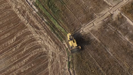Aerial-Overhead-View-Of-Yellow-Combine-Harvester-Working-In-Punjab-Field-In-Pakistan